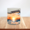  Orange sunset art printed on a ceramic mug. Sunset lover gift mug with a faux hole design. Close view of 3D illusion sunset on a mug. 
